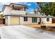 Charming two-story home featuring a tire swing, spacious driveway, and white brick exterior at 3038 E Avalon Dr, Phoenix, AZ 85016