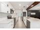 Bright kitchen with white cabinetry, stainless appliances, subway tile backsplash, and center island at 3038 E Avalon Dr, Phoenix, AZ 85016