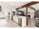 Bright kitchen with wooden beam accents, stainless steel appliances, and center island with barstool seating at 3038 E Avalon Dr, Phoenix, AZ 85016