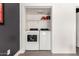 Convenient laundry room with modern, energy efficient washer and dryer units and shelving at 3038 E Avalon Dr, Phoenix, AZ 85016