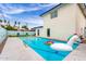 Relaxing pool area with a unicorn float, seating, and well-maintained landscaping at 3038 E Avalon Dr, Phoenix, AZ 85016