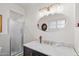 Bright bathroom with marble countertop, a clear glass shower, and a vintage vanity at 31 W Marlette Ave, Phoenix, AZ 85013