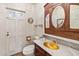 Charming bathroom featuring a marble countertop, gold fixtures, and a vintage-style vanity with mirror at 31 W Marlette Ave, Phoenix, AZ 85013