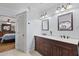Bathroom featuring a double vanity, marble countertops, and access to the main bedroom at 31 W Marlette Ave, Phoenix, AZ 85013