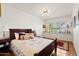 Comfortable bedroom with hardwood floors, a large window, and a cozy bed at 31 W Marlette Ave, Phoenix, AZ 85013