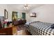 Cozy bedroom with hardwood floors, a flat-screen TV, and a comfortable bed with patterned linens at 31 W Marlette Ave, Phoenix, AZ 85013