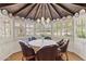 Charming breakfast nook with a round table, leather chairs, and a unique wood-beam ceiling at 31 W Marlette Ave, Phoenix, AZ 85013