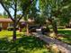 Charming home with a spacious front yard, mature trees, and an inviting patio area for relaxing at 31 W Marlette Ave, Phoenix, AZ 85013