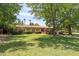 Charming home with a spacious front yard, mature trees, and an inviting patio area for relaxing at 31 W Marlette Ave, Phoenix, AZ 85013