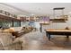 Expansive game room with a pool table, comfortable seating area, and a desert-themed television display at 31 W Marlette Ave, Phoenix, AZ 85013