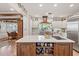 Bright kitchen with custom island, white cabinetry, stainless appliances, and a view to the dining area at 31 W Marlette Ave, Phoenix, AZ 85013