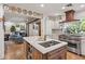 Well-equipped kitchen with island, white cabinets, stainless steel appliances and a view to the living area at 31 W Marlette Ave, Phoenix, AZ 85013