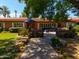 Inviting brick patio with comfortable seating and an outdoor dining area under a bright blue umbrella at 31 W Marlette Ave, Phoenix, AZ 85013