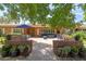 Inviting brick patio featuring comfortable seating and an outdoor dining area under a bright blue umbrella at 31 W Marlette Ave, Phoenix, AZ 85013