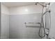The shower features gray tiles and a shower head with a hose and a towel rack at 31 W Marlette Ave, Phoenix, AZ 85013