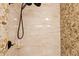 Walk-in shower showcasing neutral tile and modern fixtures with stone accents at 31 W Marlette Ave, Phoenix, AZ 85013