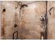 Contemporary shower featuring travertine tile, a glass enclosure, and a modern shower head at 31 W Marlette Ave, Phoenix, AZ 85013