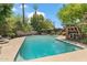 Large pool is surrounded by lush greenery and features shaded seating areas to relax and enjoy the tranquil backyard at 31 W Marlette Ave, Phoenix, AZ 85013