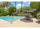 Refreshing swimming pool surrounded by lush greenery, lounge chairs, and shaded seating areas for relaxation and enjoyment at 31 W Marlette Ave, Phoenix, AZ 85013