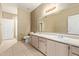 Bathroom featuring a double vanity with light wood cabinets and neutral tile floors and walls at 3236 E Chandler Blvd # 2028, Phoenix, AZ 85048