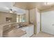 Galley kitchen featuring stainless steel sink, white cabinets, and view to living space at 3236 E Chandler Blvd # 2028, Phoenix, AZ 85048