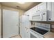 Bright kitchen showcasing white appliances, cabinets, and ample storage space at 3236 E Chandler Blvd # 2028, Phoenix, AZ 85048