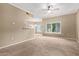 Sunlit living area boasts neutral walls, cozy carpet, and a ceiling fan at 3236 E Chandler Blvd # 2028, Phoenix, AZ 85048