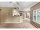 Open-concept living area with neutral carpet and views into the kitchen and balcony at 3236 E Chandler Blvd # 2028, Phoenix, AZ 85048