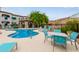 Community pool featuring lounge seating, covered ramada, and desert landscaping at 3236 E Chandler Blvd # 2028, Phoenix, AZ 85048
