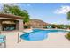 Community pool featuring lounge seating, covered ramada, and desert landscaping at 3236 E Chandler Blvd # 2028, Phoenix, AZ 85048