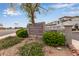 Community signage with lush landscaping, creating a welcoming entrance at 3236 E Chandler Blvd # 2028, Phoenix, AZ 85048