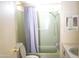Bathroom with a tub and shower combination with a light green surround and a gray shower curtain at 345 S 58Th St # 10, Mesa, AZ 85206