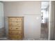Bedroom featuring a wooden dresser with drawers, offering ample storage space, and a view into an adjacent room at 345 S 58Th St # 10, Mesa, AZ 85206