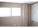 Bedroom featuring two windows providing natural light and a closet with double doors for ample storage at 345 S 58Th St # 10, Mesa, AZ 85206