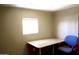 A bedroom with a desk, chair and a window is illuminated with natural light at 345 S 58Th St # 10, Mesa, AZ 85206