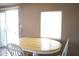 Dining room with a wooden table and chairs next to a sliding glass door and window, providing a bright atmosphere at 345 S 58Th St # 10, Mesa, AZ 85206