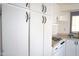Functional kitchen with white cabinetry, gas range, and bright natural light at 345 S 58Th St # 10, Mesa, AZ 85206