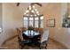 Elegant dining room featuring a chandelier, large windows with shutters, and beautiful tile flooring at 35195 N 98Th St # 85, Scottsdale, AZ 85262