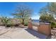 Outdoor kitchen area featuring a built-in stainless steel grill and lush desert landscaping creating a perfect setting at 35195 N 98Th St # 85, Scottsdale, AZ 85262