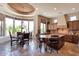 Open kitchen with granite counters, custom cabinets, a central island, and an adjacent dining area at 35195 N 98Th St # 85, Scottsdale, AZ 85262