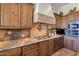 Gourmet kitchen features granite countertops, custom cabinets, and a tiled backsplash with a stainless steel range at 35195 N 98Th St # 85, Scottsdale, AZ 85262