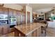 Kitchen featuring custom cabinets, stainless steel appliances, granite countertops, and central island with seating at 35195 N 98Th St # 85, Scottsdale, AZ 85262