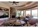 Bright living room with stone fireplace, ceiling fan, recessed lighting, and stylish furnishings at 35195 N 98Th St # 85, Scottsdale, AZ 85262