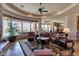 Open living room featuring a fireplace, large windows, and luxurious furnishings at 35195 N 98Th St # 85, Scottsdale, AZ 85262