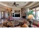 Bright living room with stone fireplace, ceiling fan, recessed lighting, and stylish furnishings at 35195 N 98Th St # 85, Scottsdale, AZ 85262