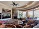 Comfortable living room featuring a stone fireplace, big-screen tv, and large windows at 35195 N 98Th St # 85, Scottsdale, AZ 85262