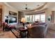 Inviting living room with a stone fireplace, a ceiling fan, and ample seating, offering a perfect place to relax at 35195 N 98Th St # 85, Scottsdale, AZ 85262