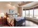 Elegant main bedroom with a bay window, hardwood floors, and a decorative wooden bed frame at 35195 N 98Th St # 85, Scottsdale, AZ 85262