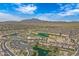 Expansive aerial view of the community showcasing the golf course, lakes, and residential areas against a mountain backdrop at 3640 E Torrey Pines Ln, Chandler, AZ 85249