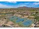 Community aerial view featuring well-maintained tennis courts and surrounding neighborhoods with mountain views at 3640 E Torrey Pines Ln, Chandler, AZ 85249